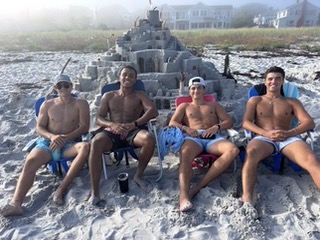 Summer visitors: Timmy from Tennessee, Otto from Massachusetts, Tommy from Oregon, and Ryan from New York show off thei sand castle. (Photo by Nancy Viehmann)